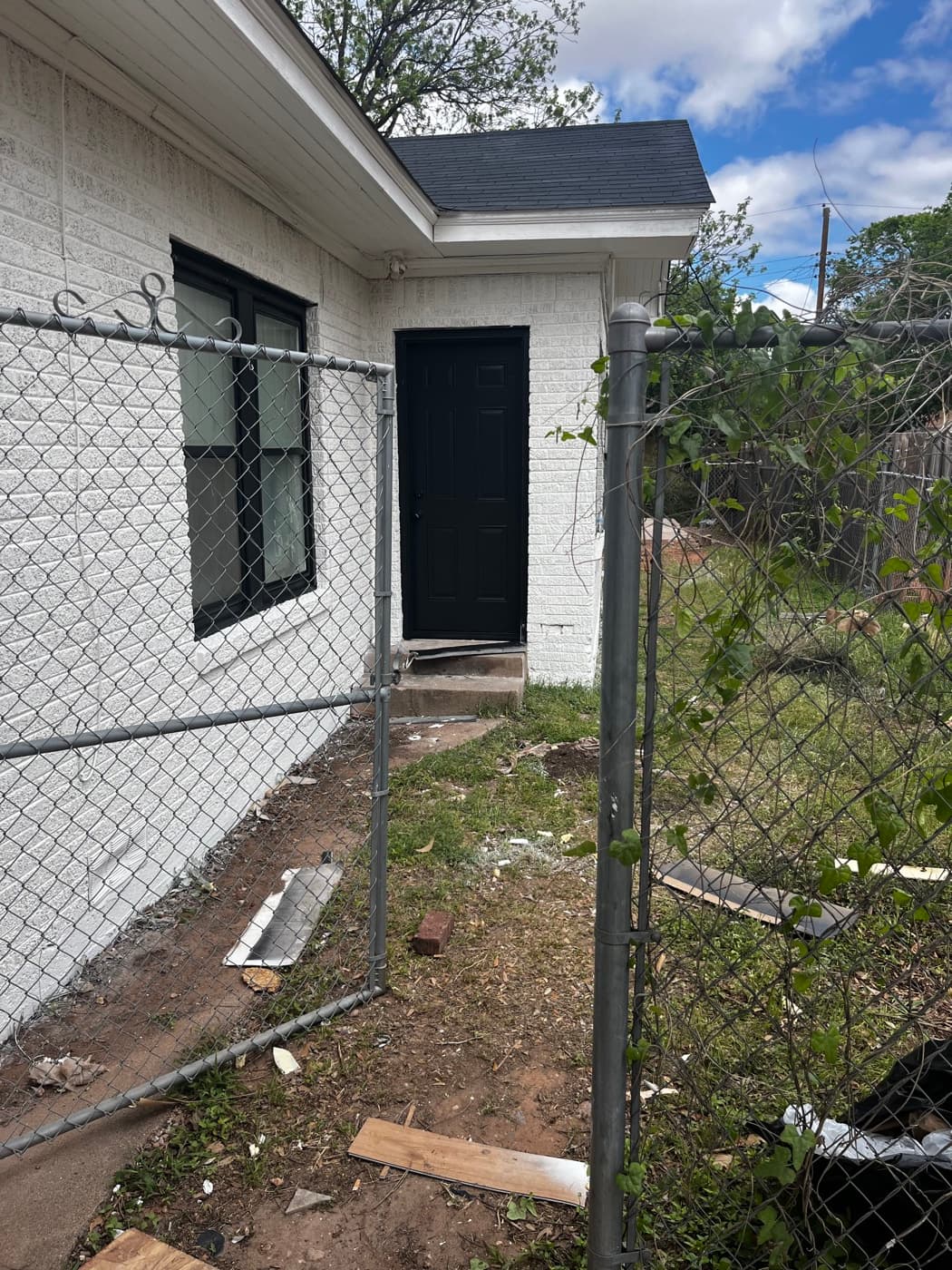 White brick exterior after repaint with black windows and black front door
