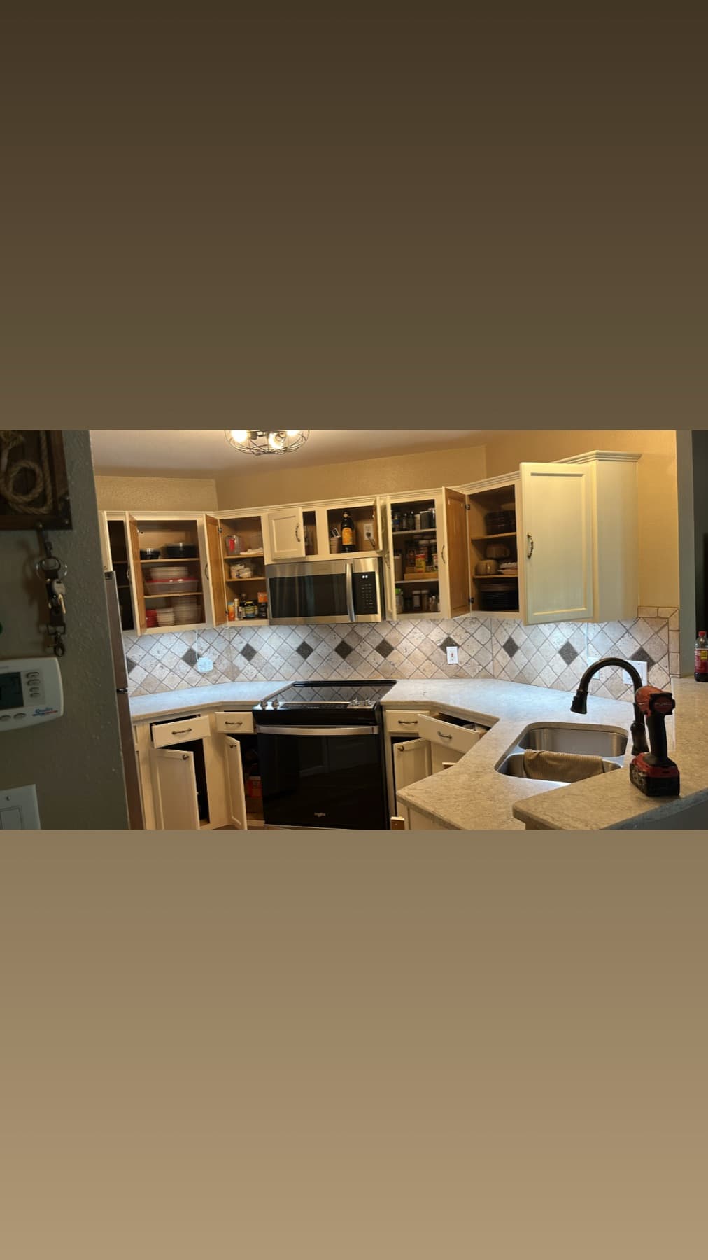 Kitchen cabinets after repainting with light cabinet finish